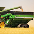 Double Auger Grain Cart Catching In Field Close Up